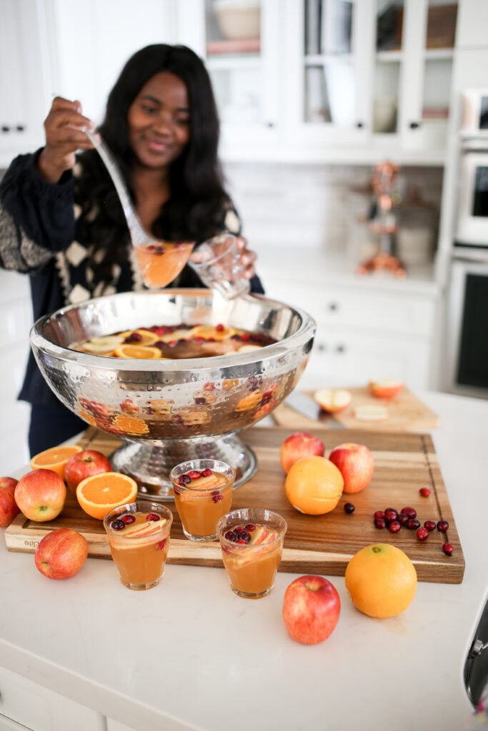 Best Thanksgiving Day Punch with oranges, apples and cranberries.