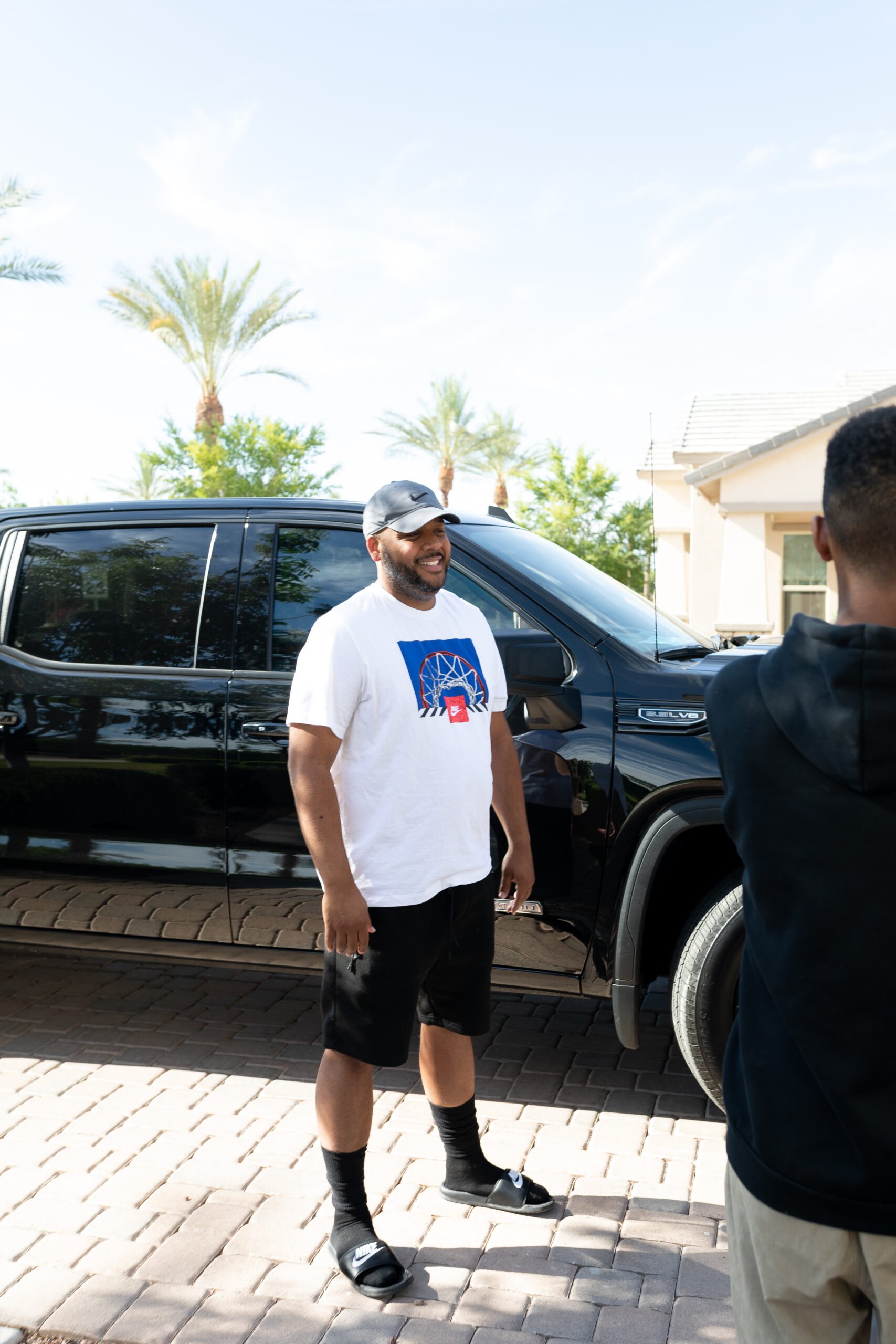 Dad in front of black GMC truck