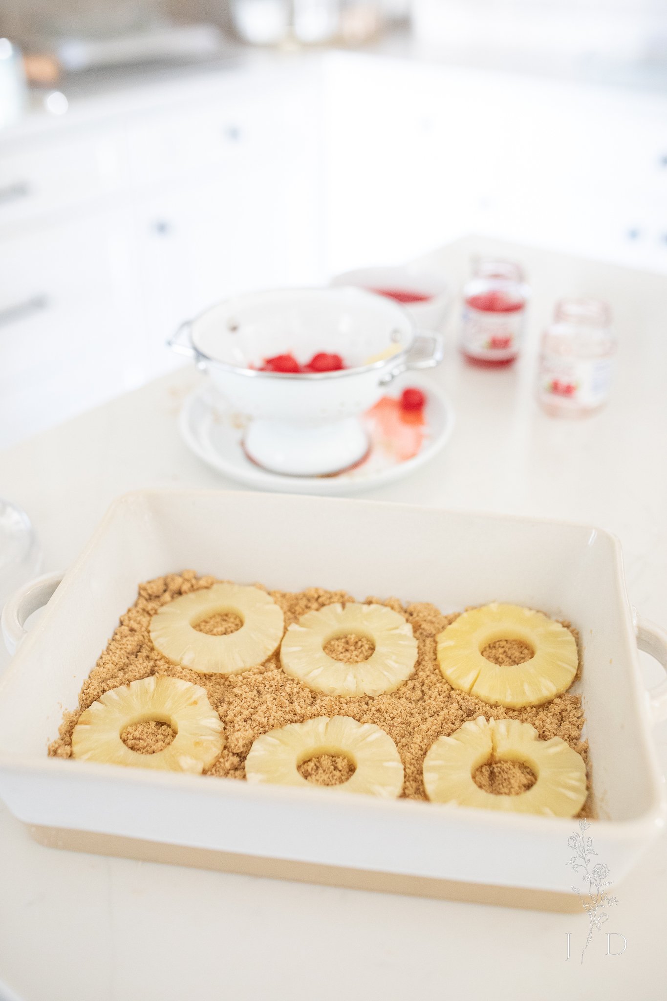 Brown Sugar and Pineapple slices in the bottom of a pan. Prepping for pineapple upside down cake. 