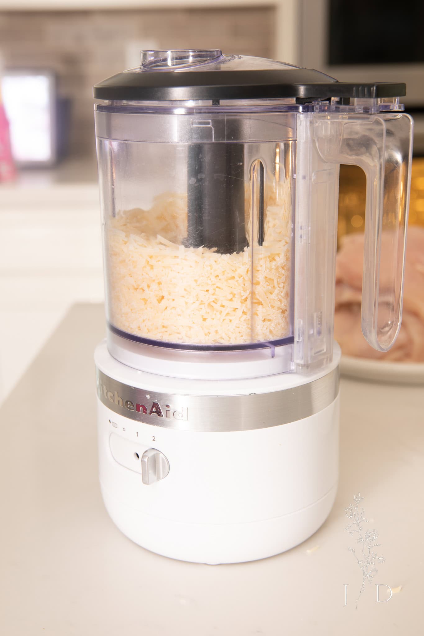 kitchen aid chopper in white with cheese in it 