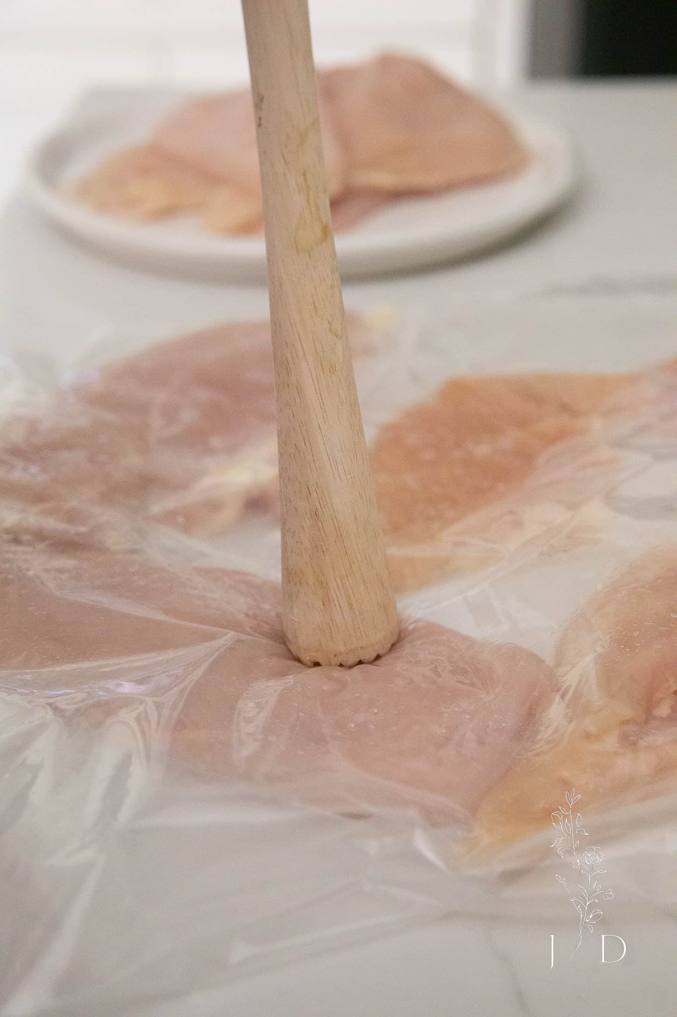 hammering chicken so that it's flat 